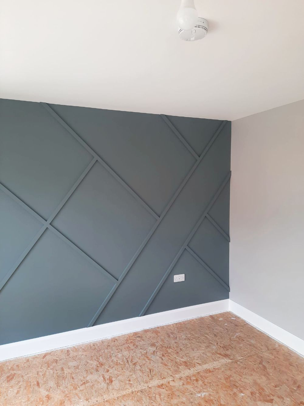 A room with a blue wall and a wooden floor.