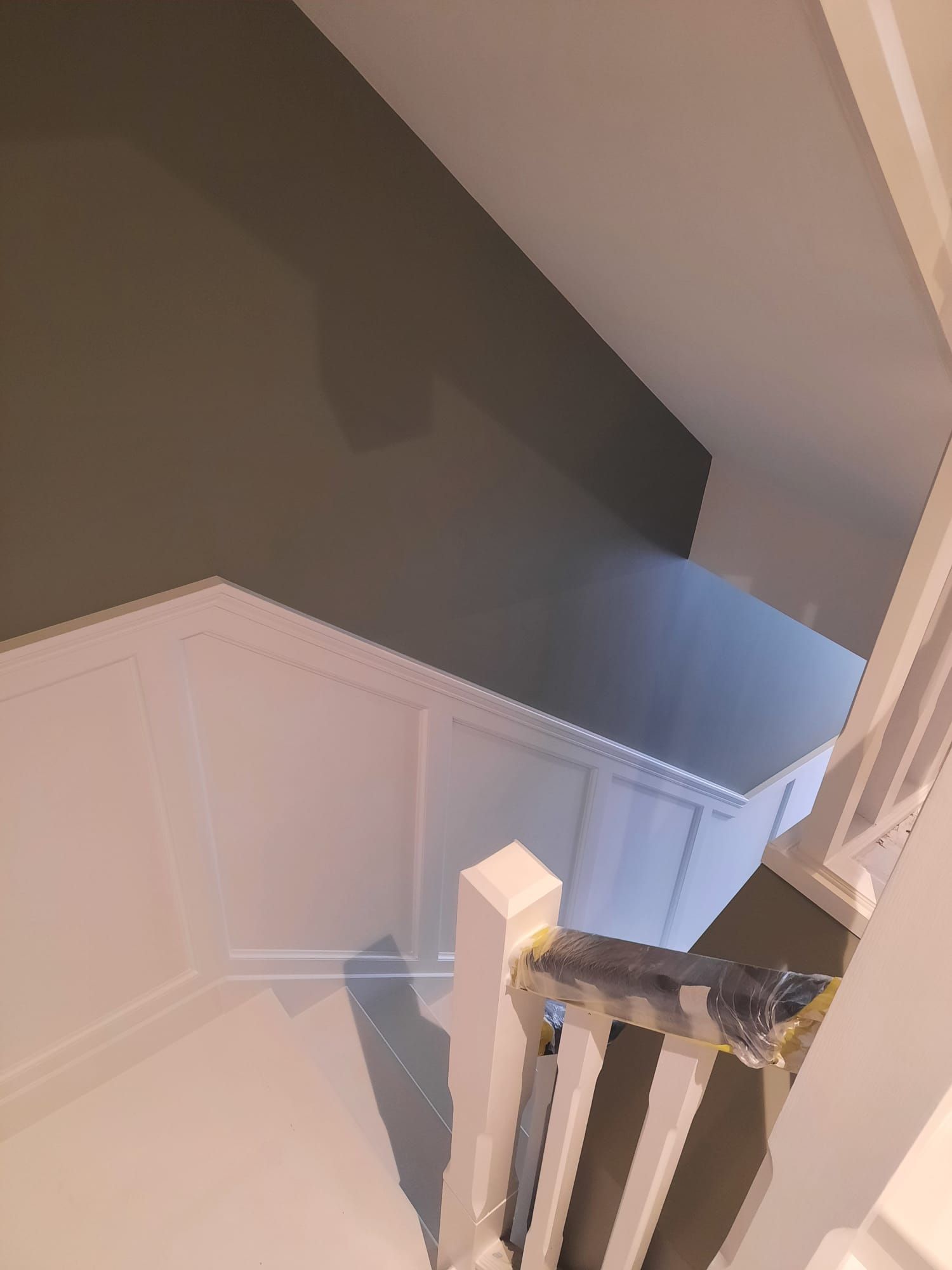 A view of a staircase from the top of the stairs.