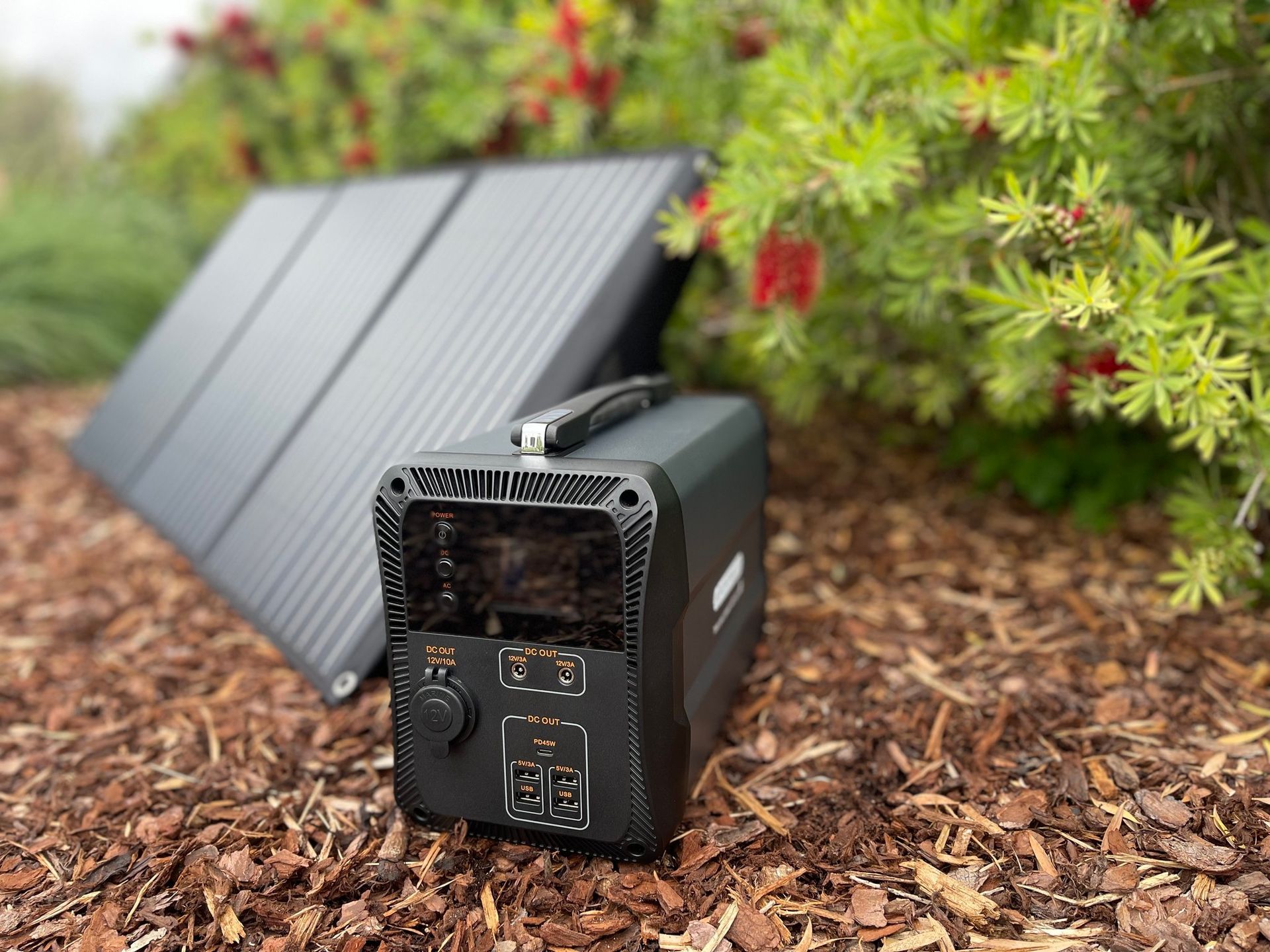 A Portable Power Station With A Solar Panel Attached To It Is Sitting On The Ground —  Accidental Health & Safety NQ & Mt Isa In Garbutt, QLD