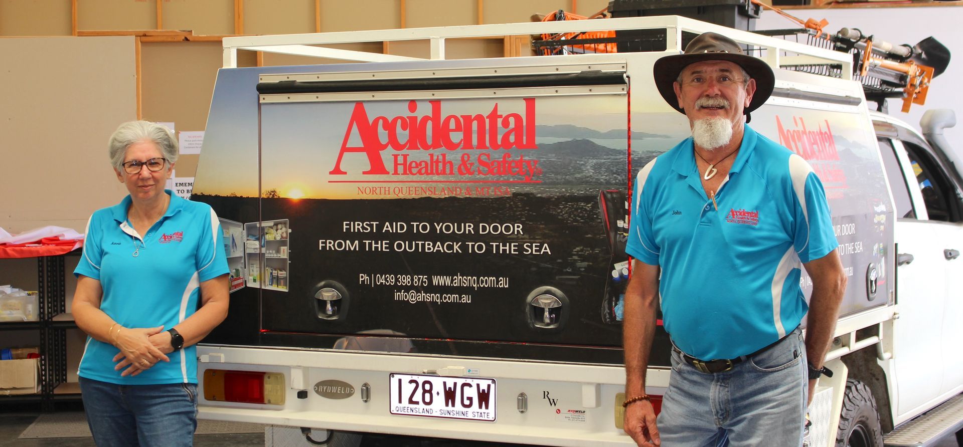 Man And Lady Standing By The Rear Of A Vehicle — Accidental Health & Safety NQ & Mt Isa In Garbutt, QLD