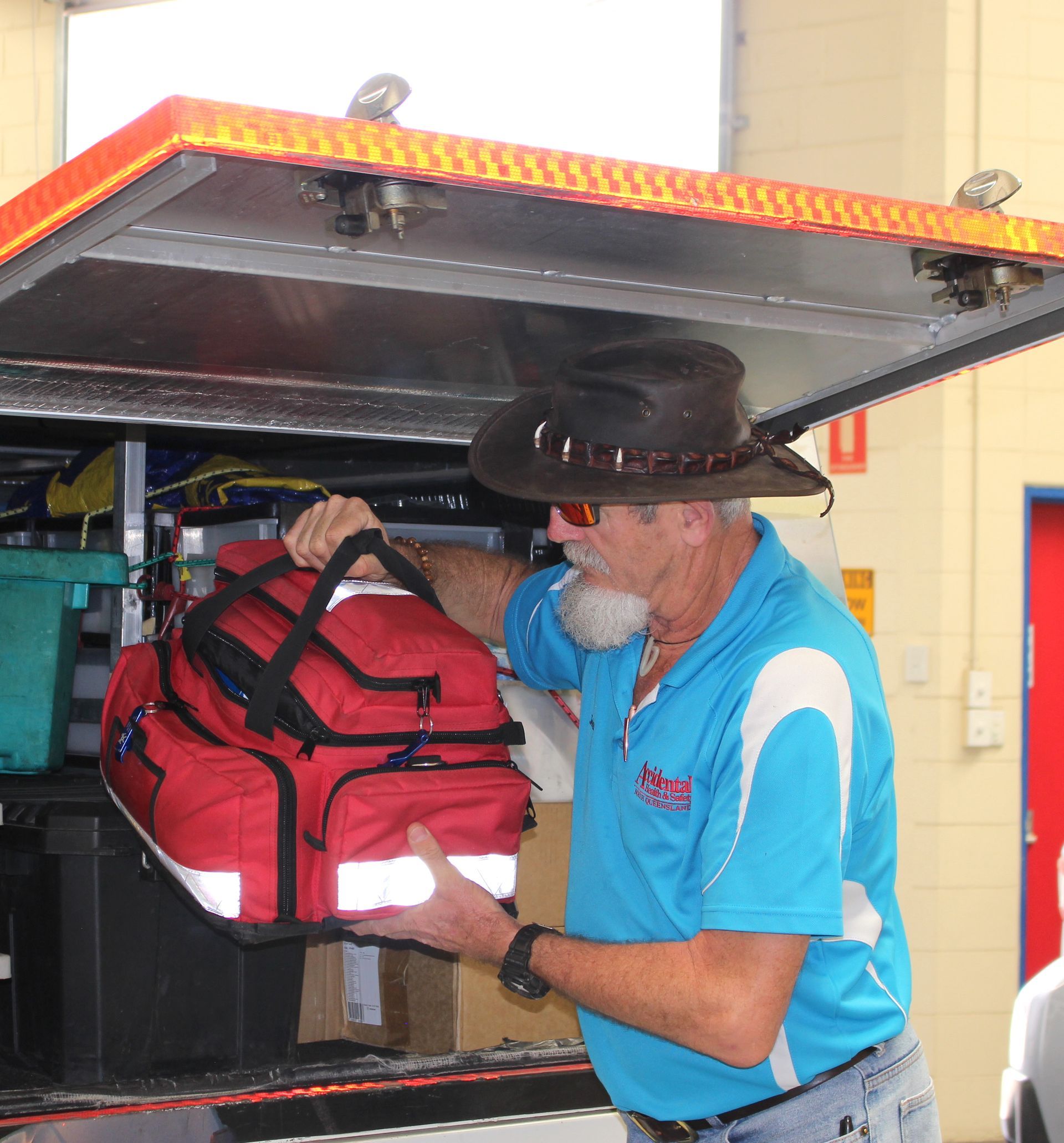 A Man In A Cowboy Hat Holds A Red Bag —  Accidental Health & Safety NQ & Mt Isa In Garbutt, QLD