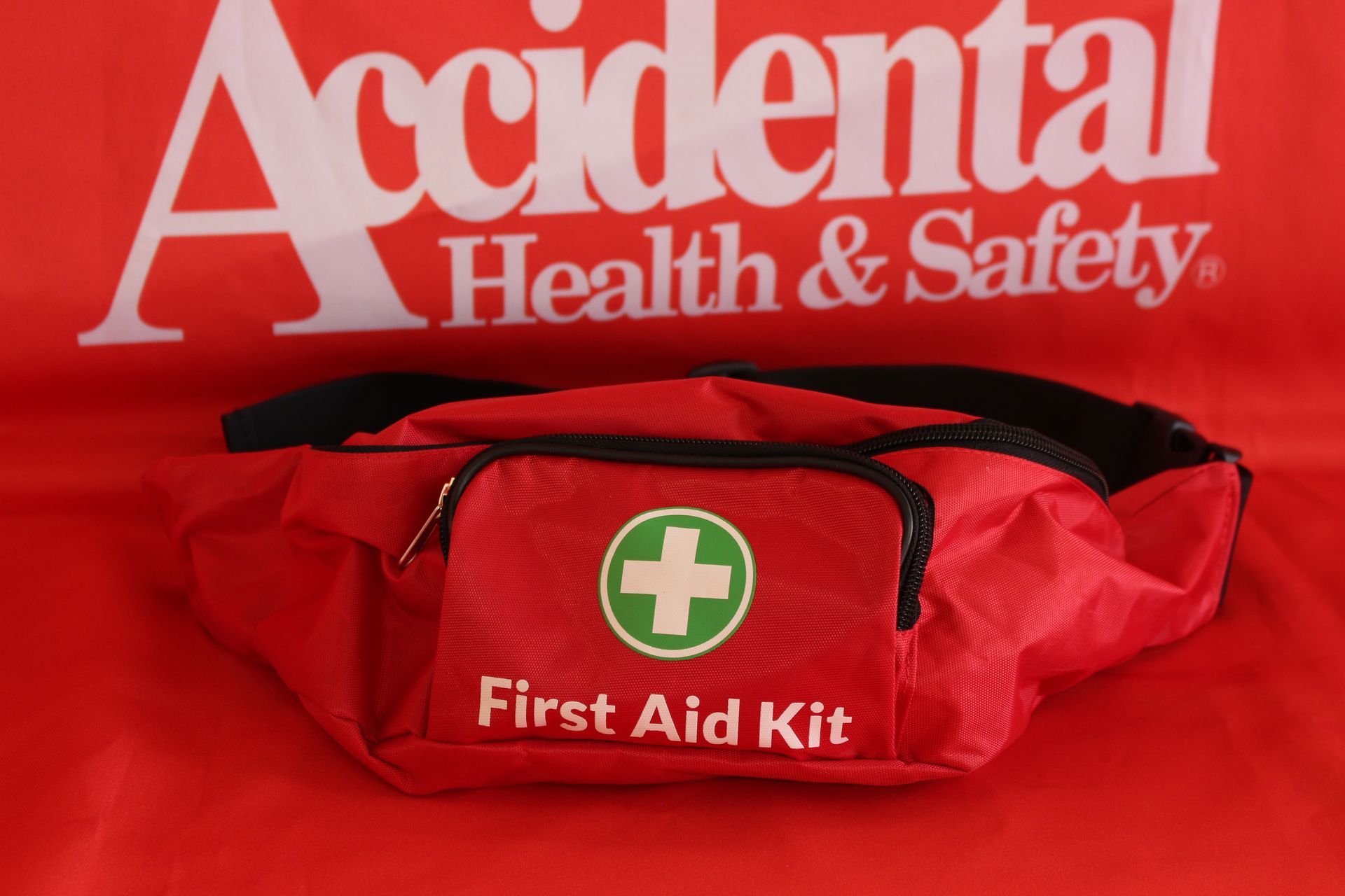 A Red First Aid Kit Is On A Red Accidental Health And Safety Shirt —  Accidental Health & Safety NQ & Mt Isa In Ingham, QLD