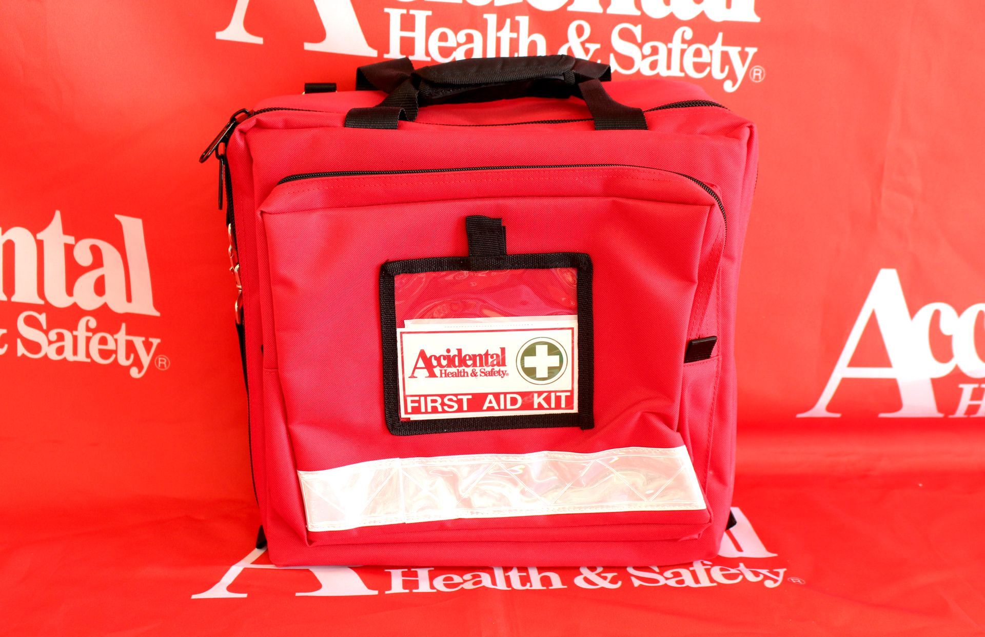 A Red First Aid Kit Is Sitting On A Red Health And Safety Banner  —  Accidental Health & Safety NQ & Mt Isa In Mt Isa, QLD