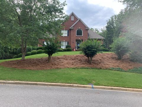 A large brick house with a lot of trees in front of it