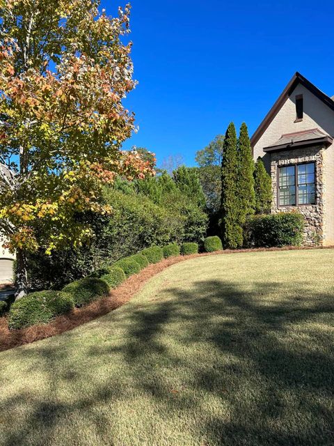 A house with a large lawn in front of it.