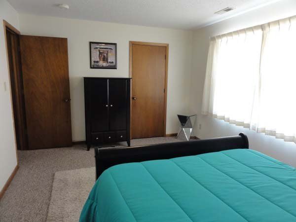 Bed With Black Cabinet — Manhattan, KS — Plaza West Apartments