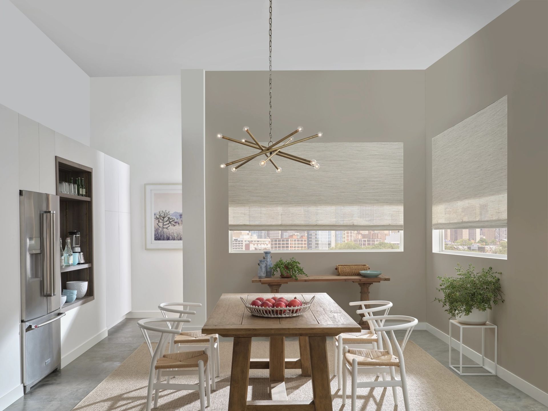 Modern dining room with a wood table, white chairs, large windows, and a hanging starburst chandelier