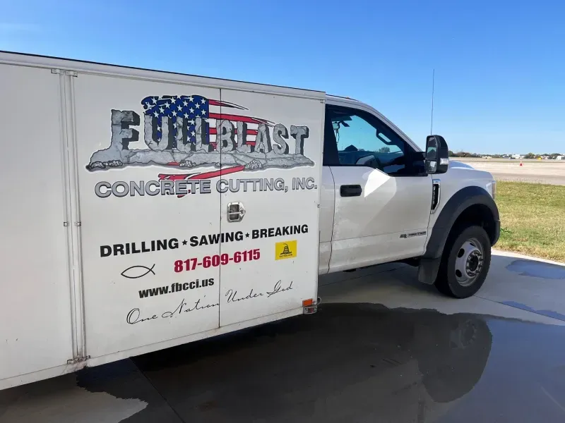 A white service truck with the company name 