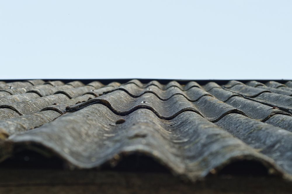 Close-up of a Weathered, Corrugated Gray Roof — Walsh Demolition Pty Ltd in Coffs Harbour, NSW