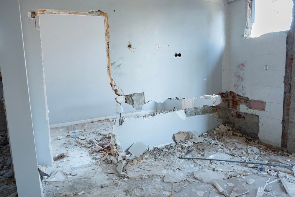 Interior Demolition, A Wall Partially Torn Down, Revealing Brick — Walsh Demolition Pty Ltd in Coffs Harbour, NSW