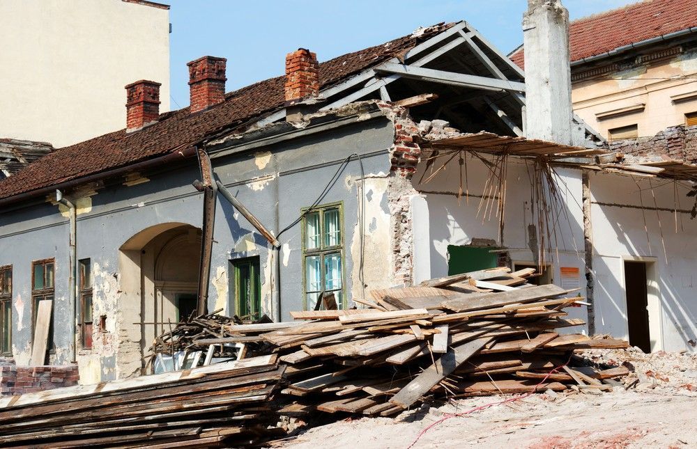 Partially Demolished Building with Exposed Roof Beams and Debris — Walsh Demolition Pty Ltd in Inverell, NSW