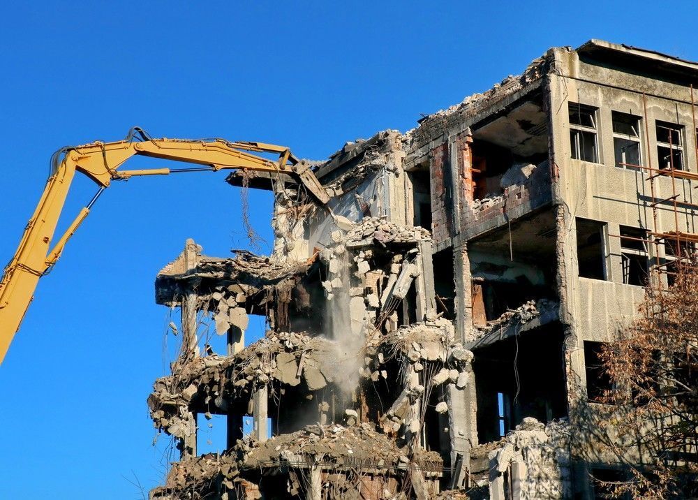 Demolition of A Multi-Story Building with A Large Yellow Excavator — Walsh Demolition Pty Ltd in Inverell, NSW