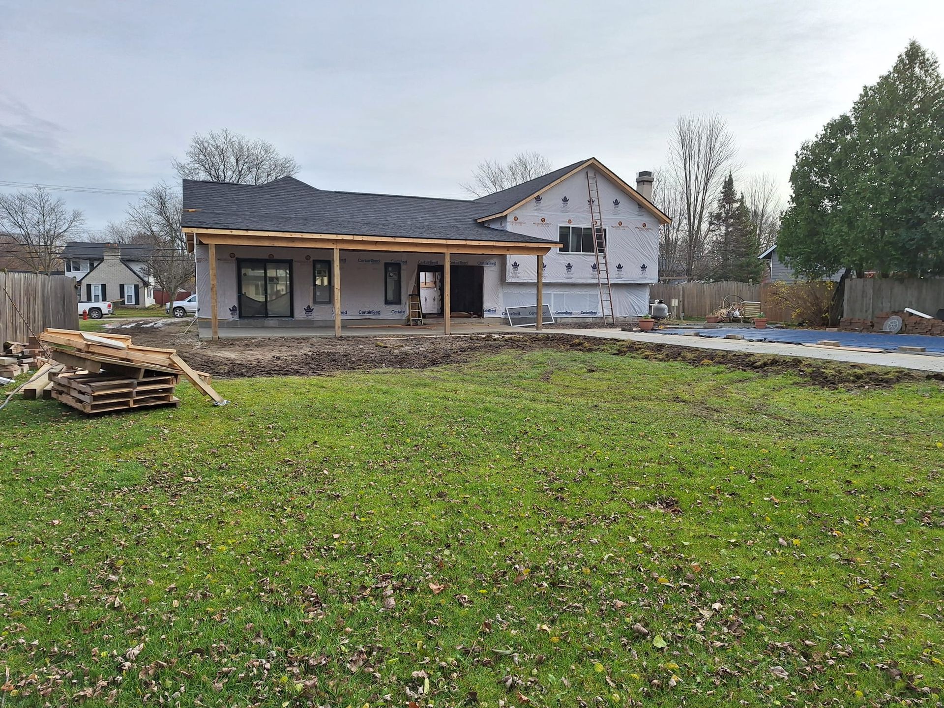 A house is being built in the middle of a grassy field.