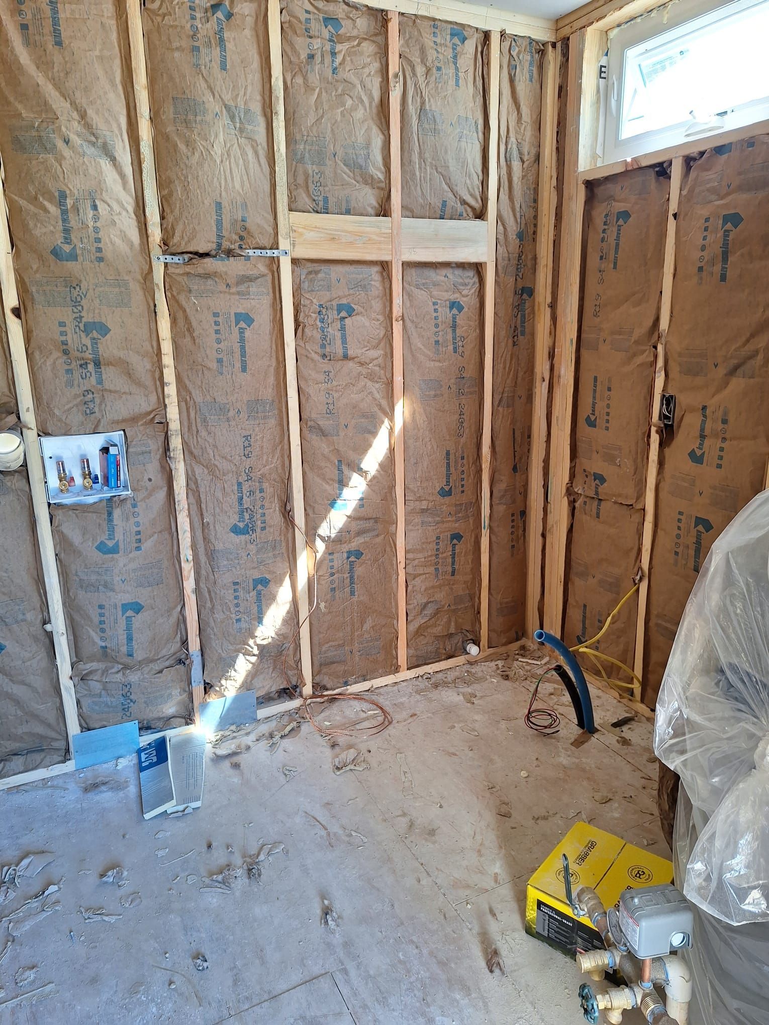 A room with a lot of insulation on the walls and a window.