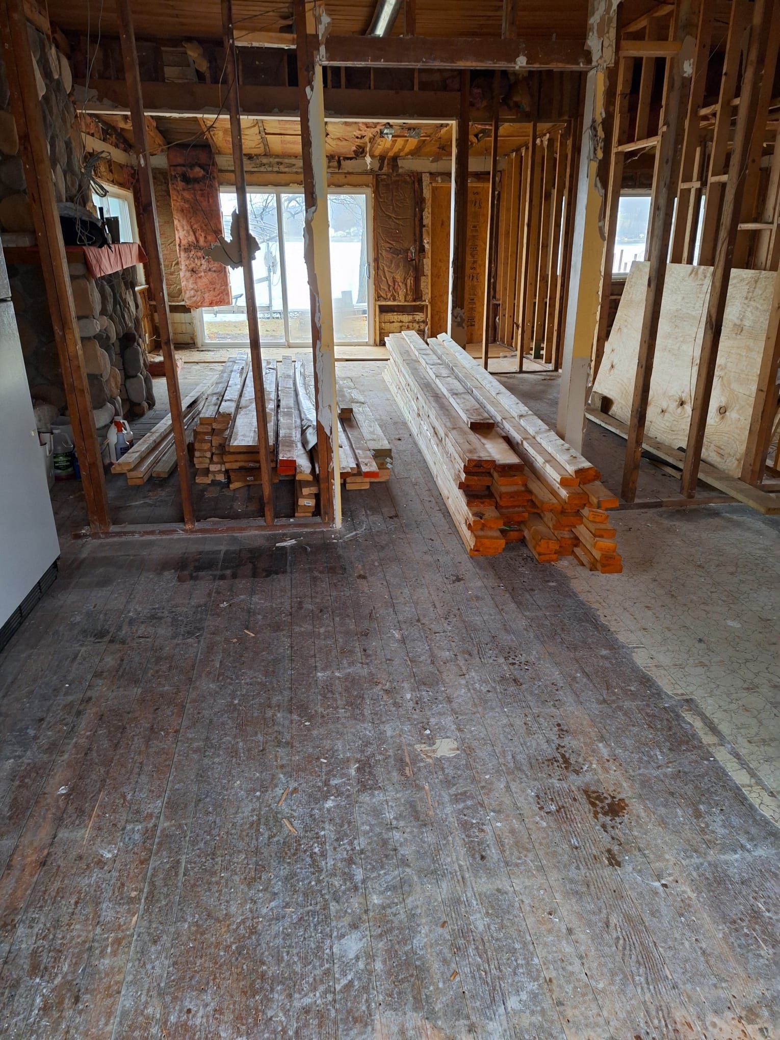 A room with a lot of wooden pieces on the floor.