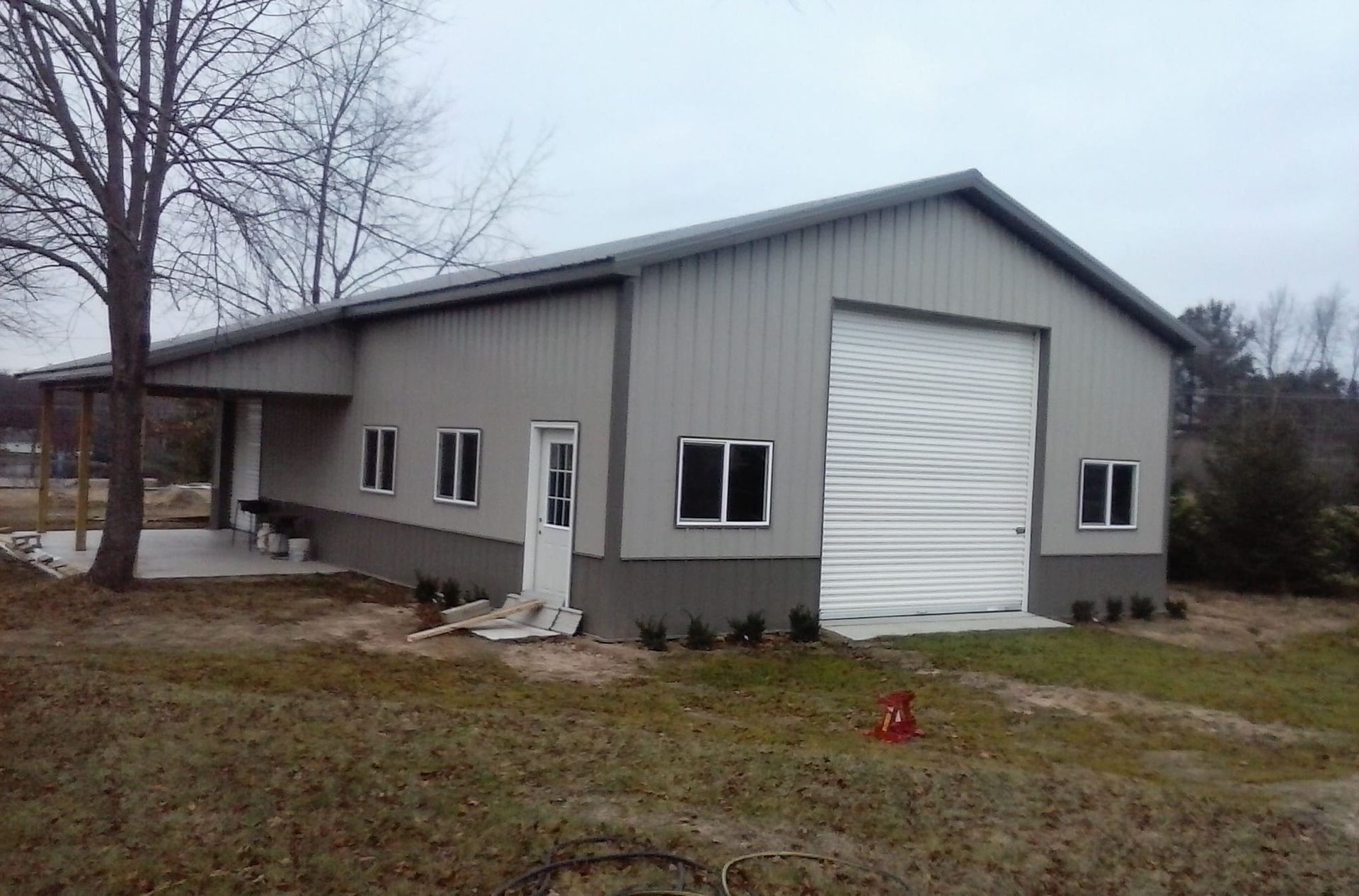 A large gray building with a white garage door