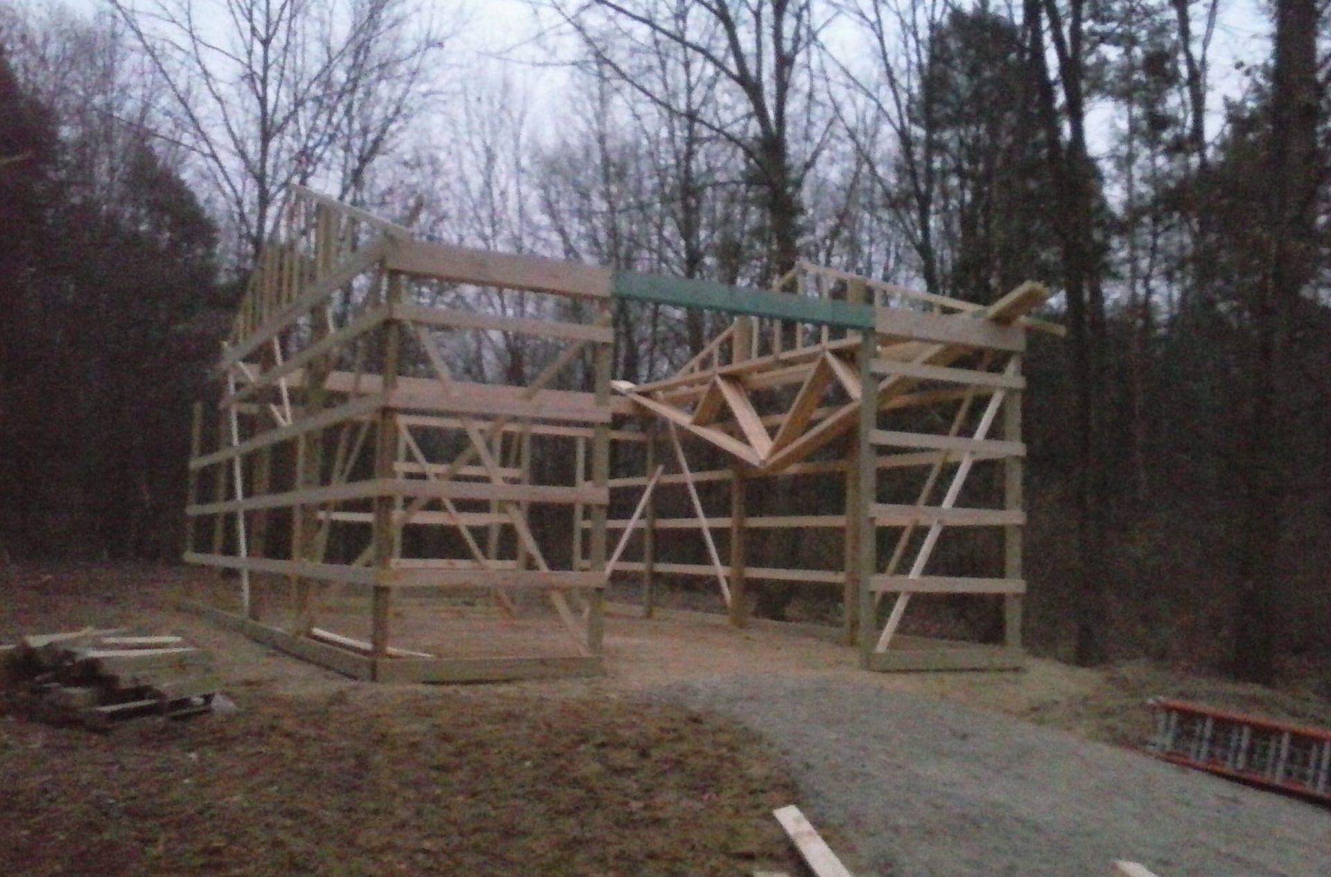 A wooden structure is being built in the middle of a forest