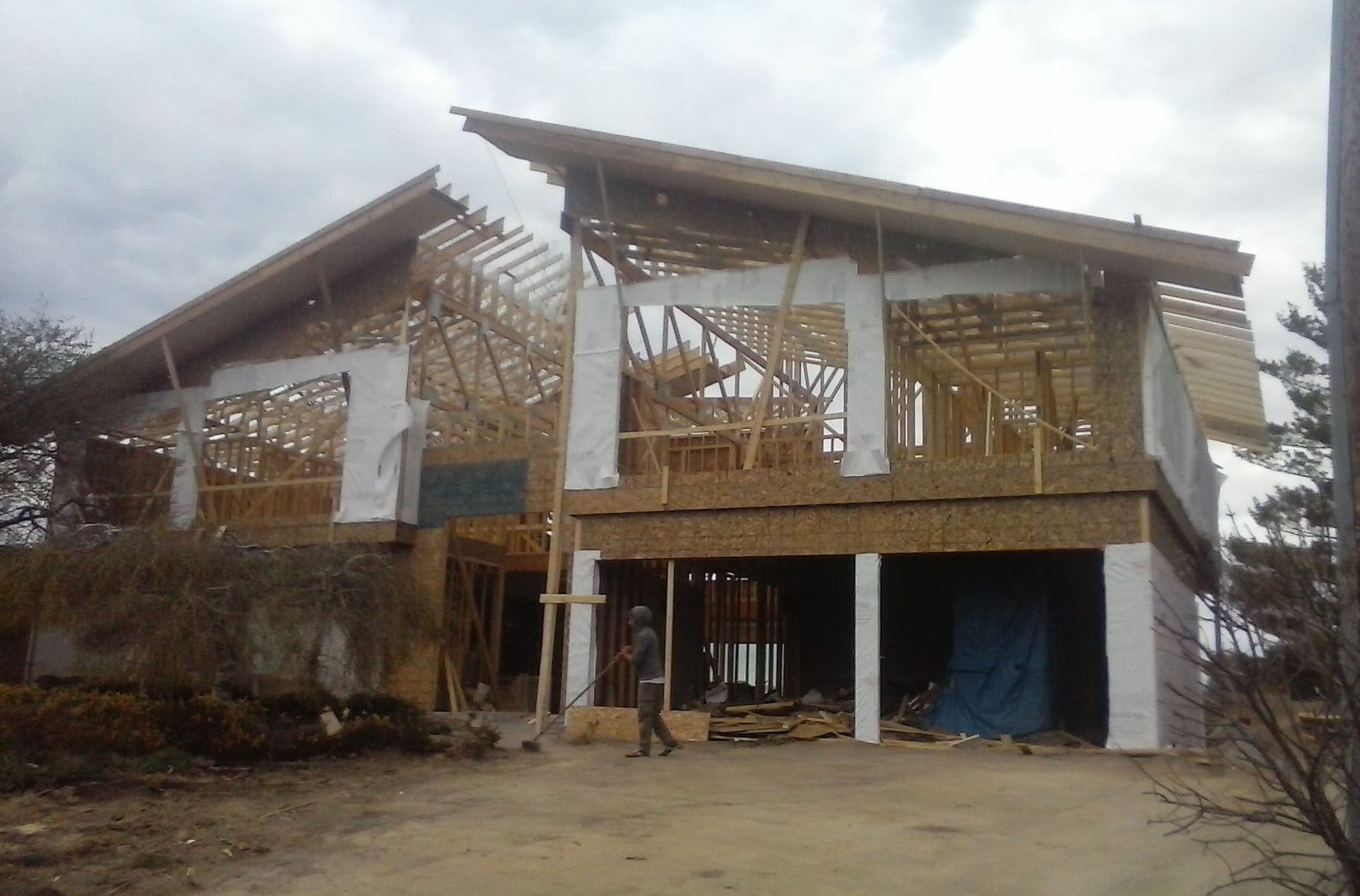 a house addition being completed by workers 