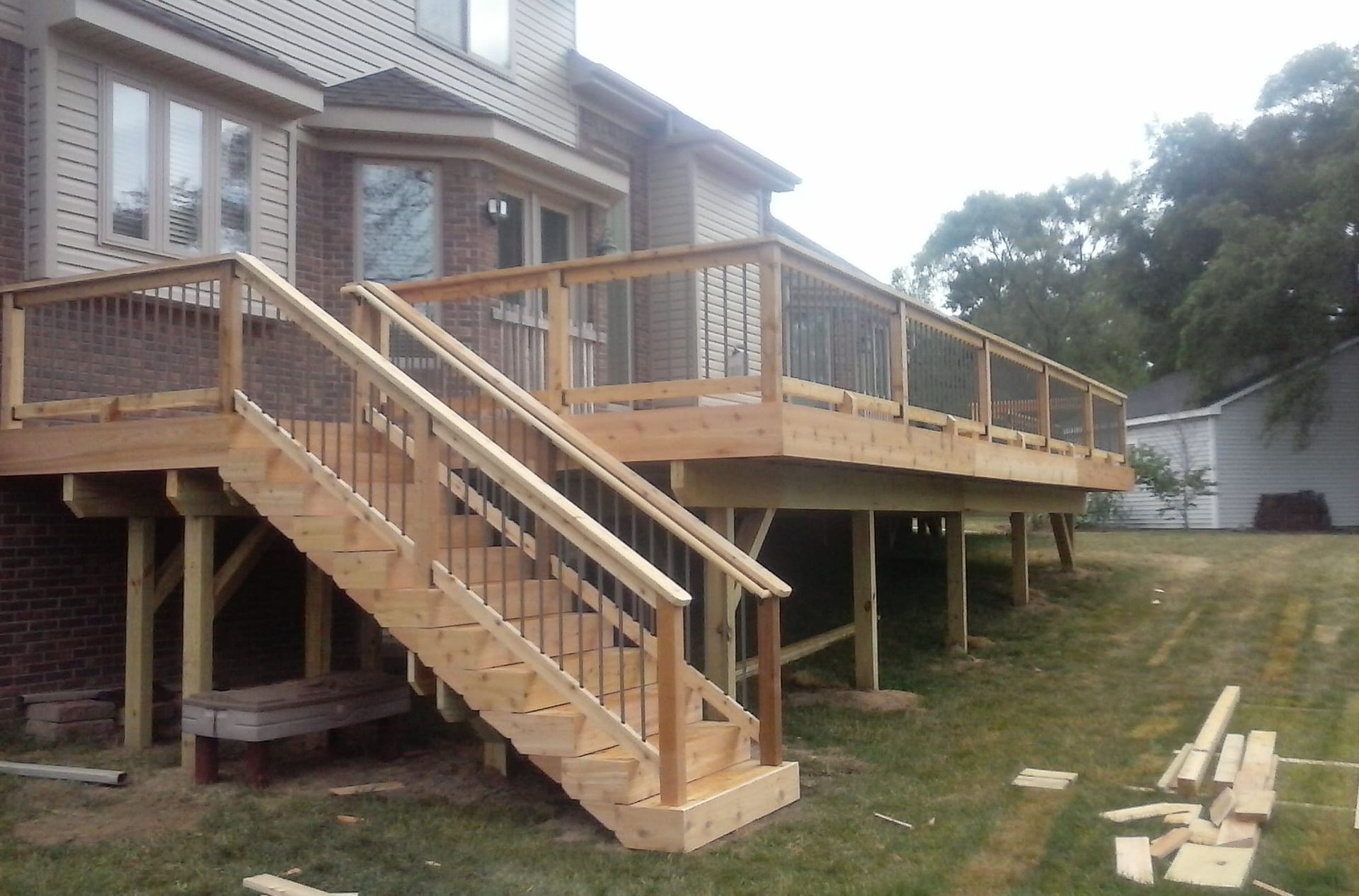 A wooden deck with stairs leading up to it