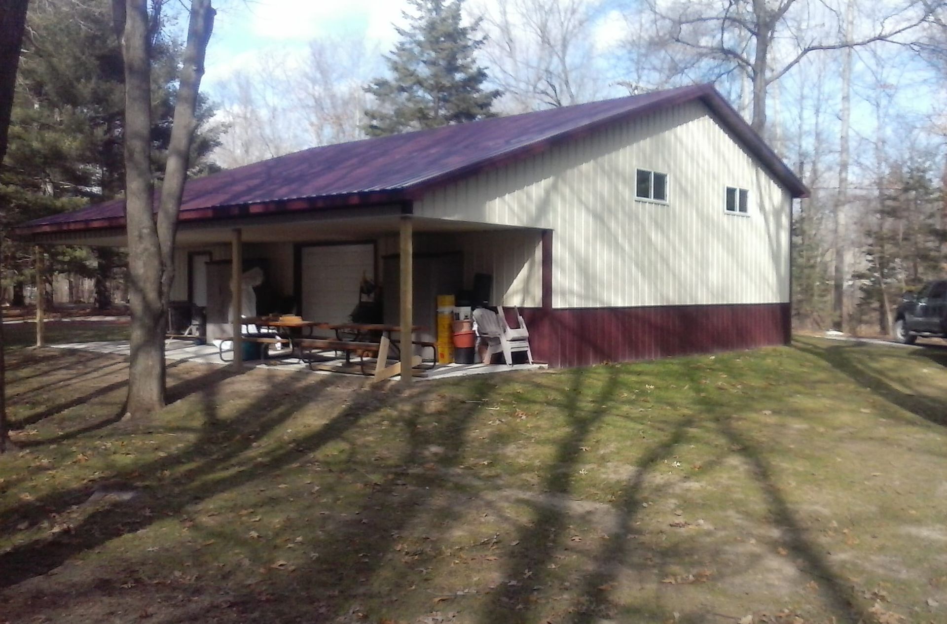 A white house with a purple roof and a porch