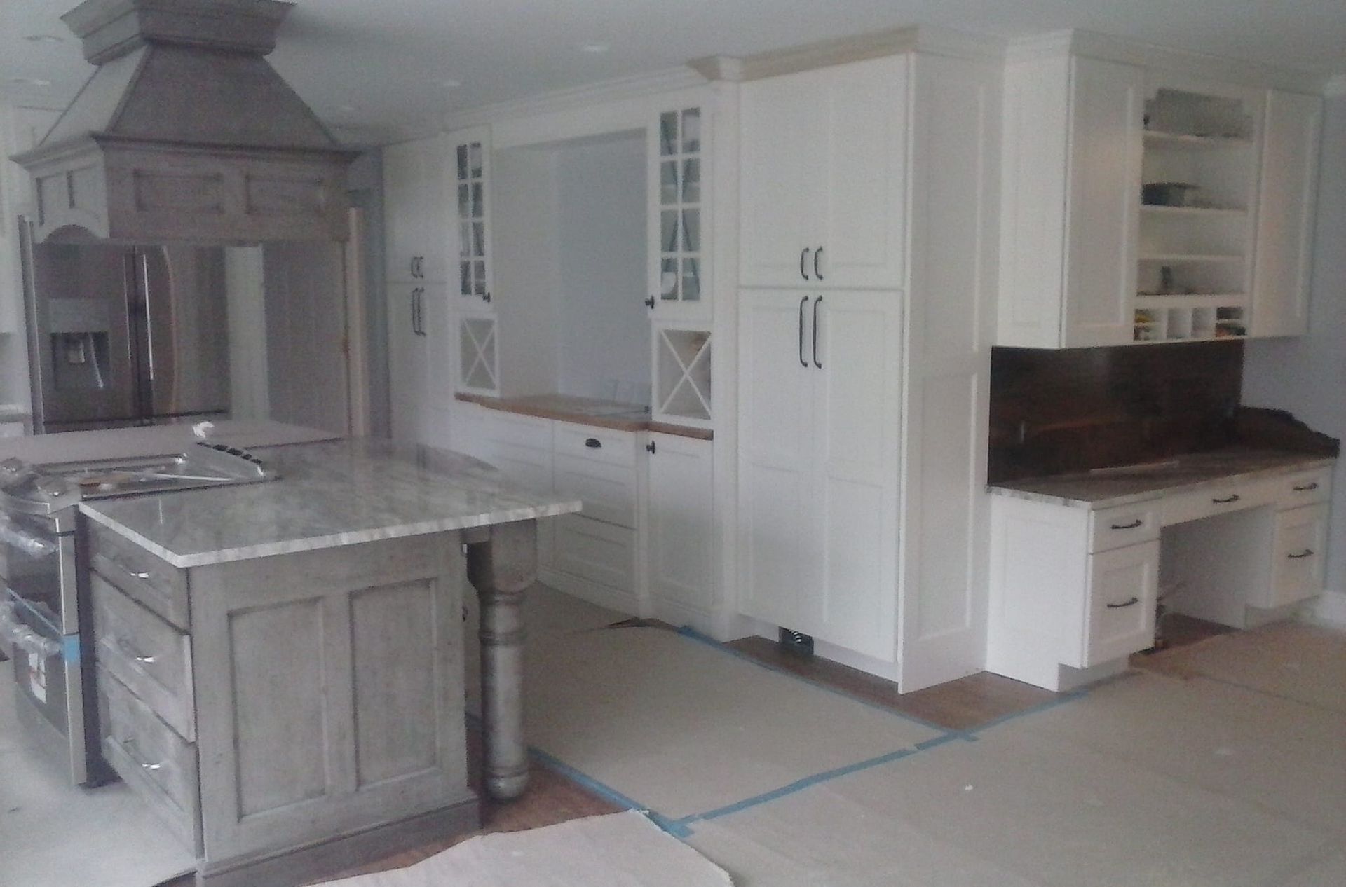 A kitchen with white cabinets and granite counter tops