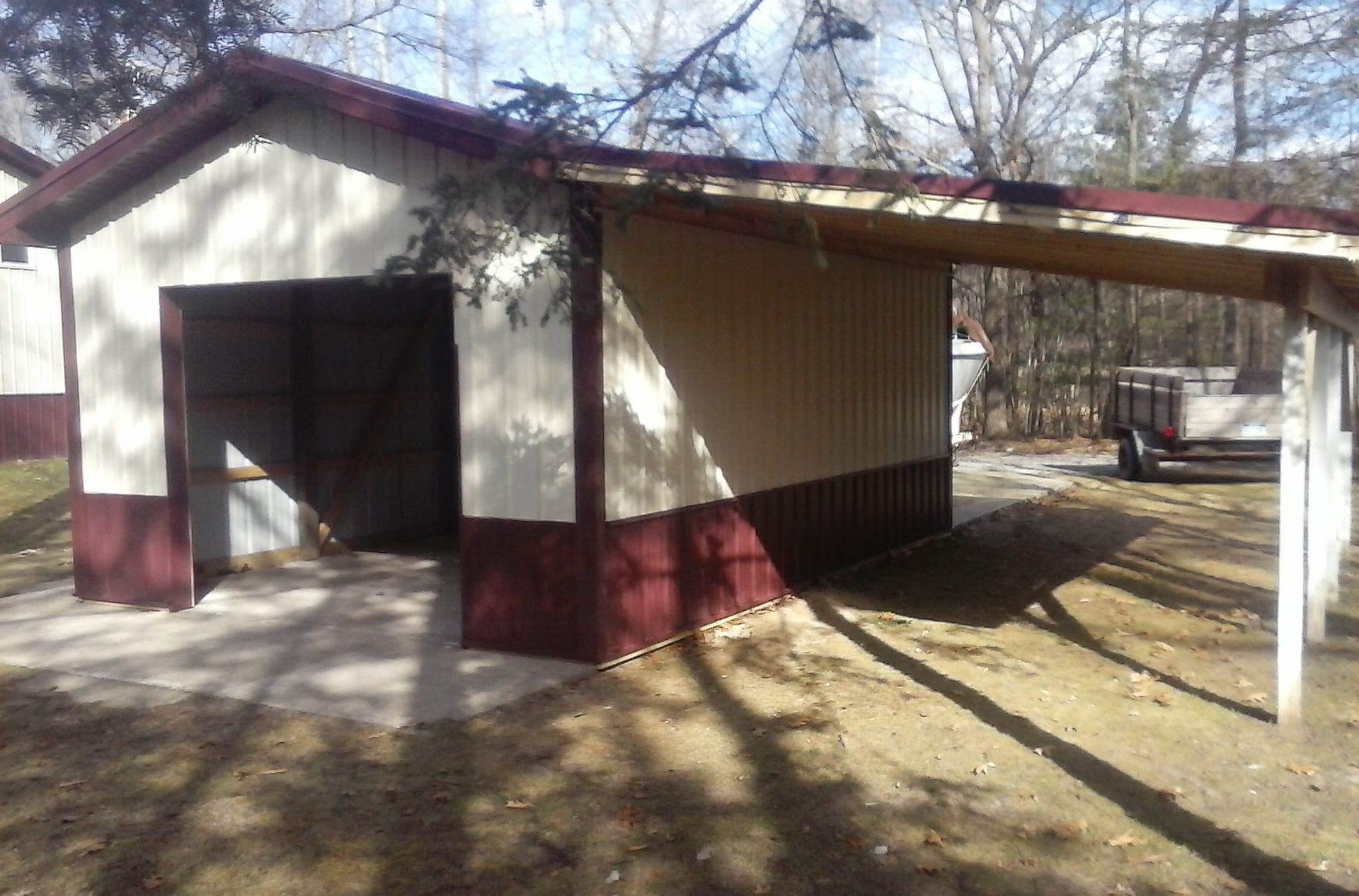 A white and red garage with a red roof