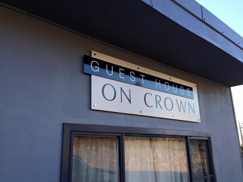A guest house on crown sign hangs above a window — McKnight Signs In Hillvue, NSW