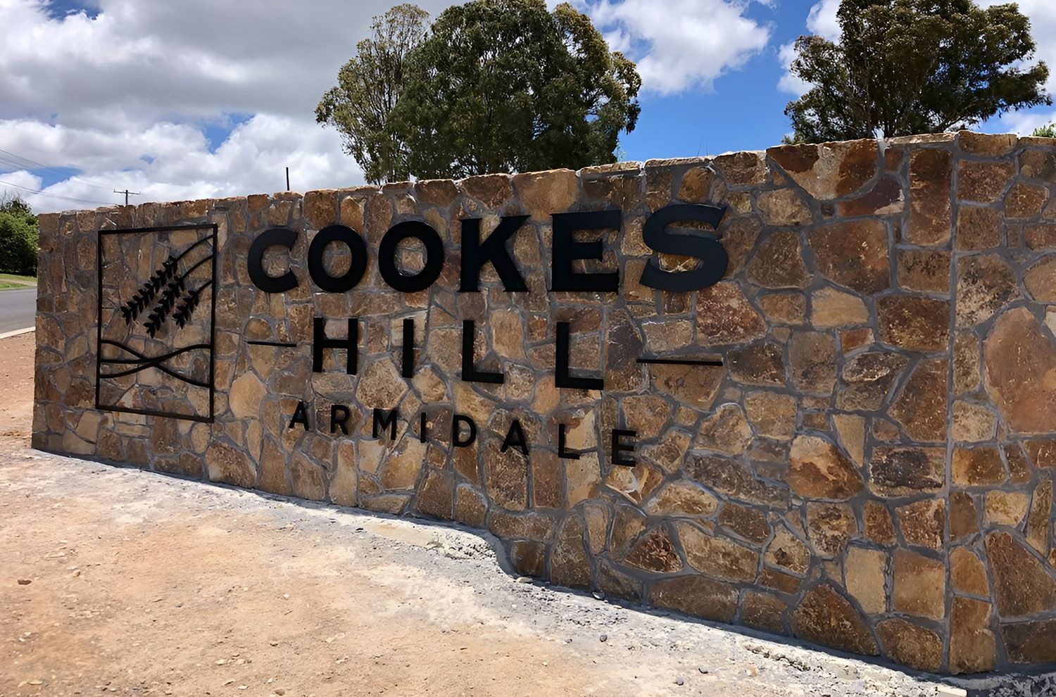 A Commercial Signage Of COOKES HILL ARMIDALE With A Wheat Graphic