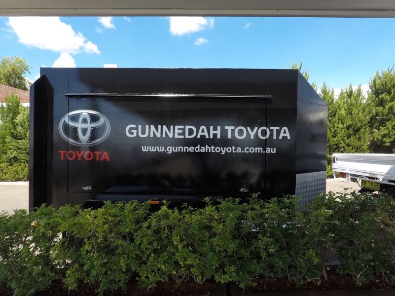 A Sign For Gunnedah Toyota Sits In Front Of Bushes — McKnight Signs In Hillvue, NSW