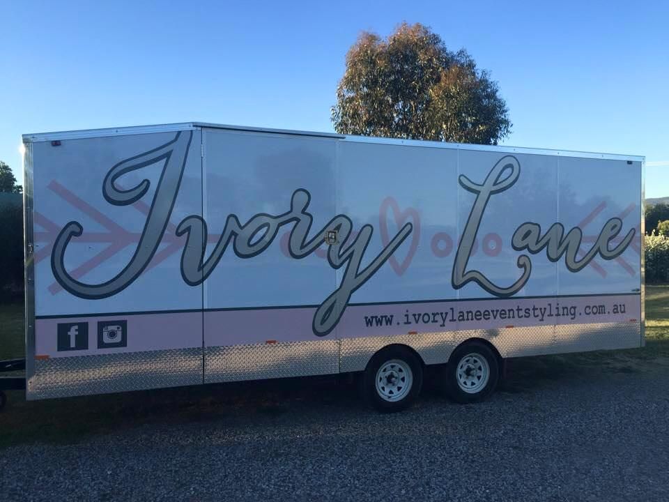A Trailer For Ivory Lane Is Parked On The Side Of The Road — McKnight Signs In Hillvue, NSW