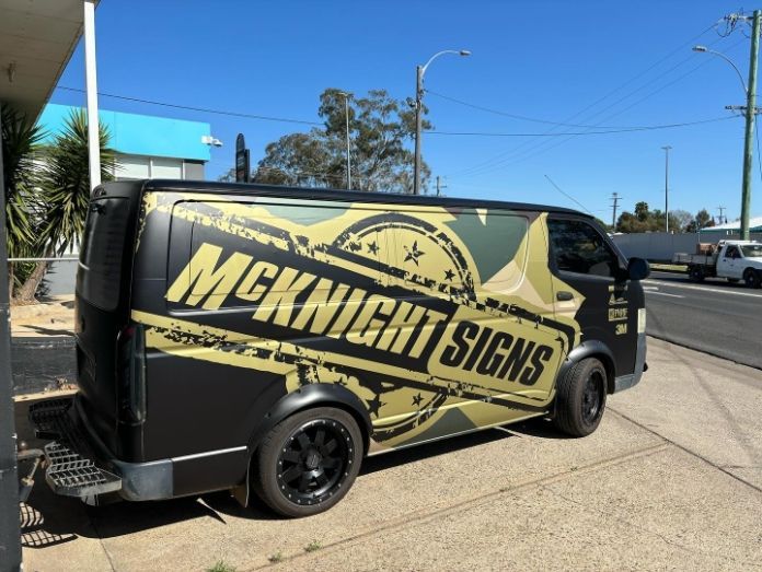 A Mcknight Signs Van Is Parked On The Side Of The Road — McKnight Signs In Hillvue, NSW