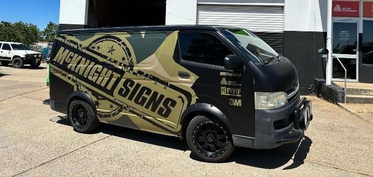 A Van Is Parked In Front Of A Building That Says Mcknight Signs — McKnight Signs In Hillvue, NSW