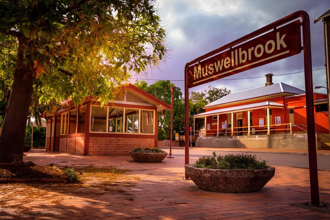A Red Sign That Says Muswellbrook Is In Front Of A Building — McKnight Signs In Muswellbrook, NSW