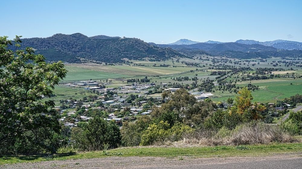 A View Of A City From A Hill With Mountains In The Background — McKnight Signs In Quirindi, NSW