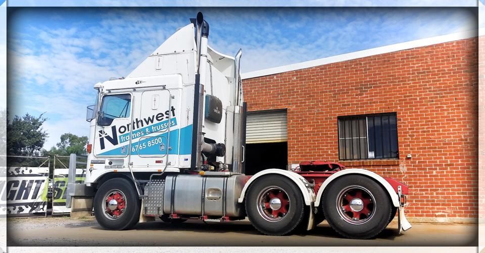 A Northwest Truck Is Parked In Front Of A Brick Building — McKnight Signs In Hillvue, NSW