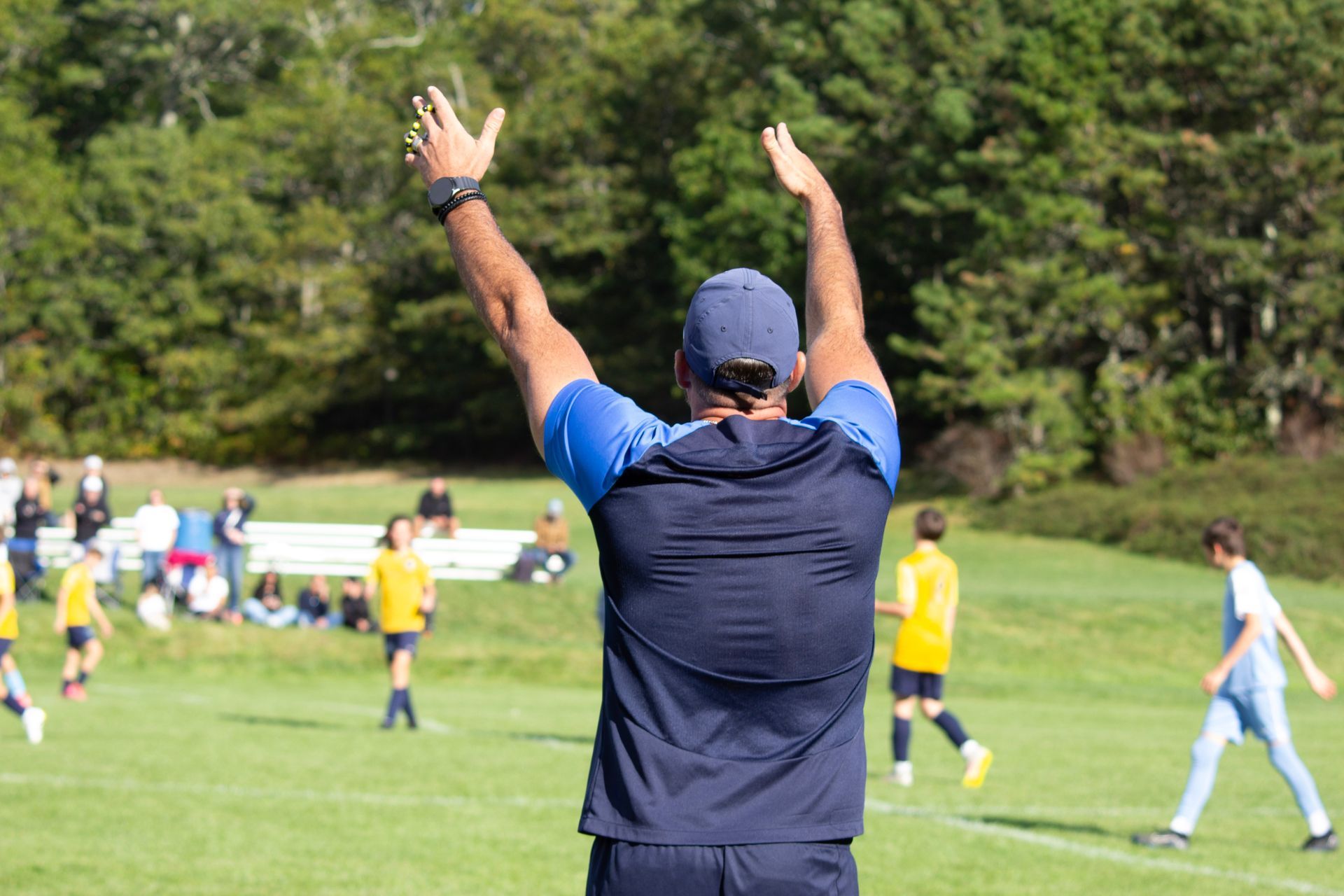 Assistant Boys Director Dom coaching an ACI Boys team from the sidelines.