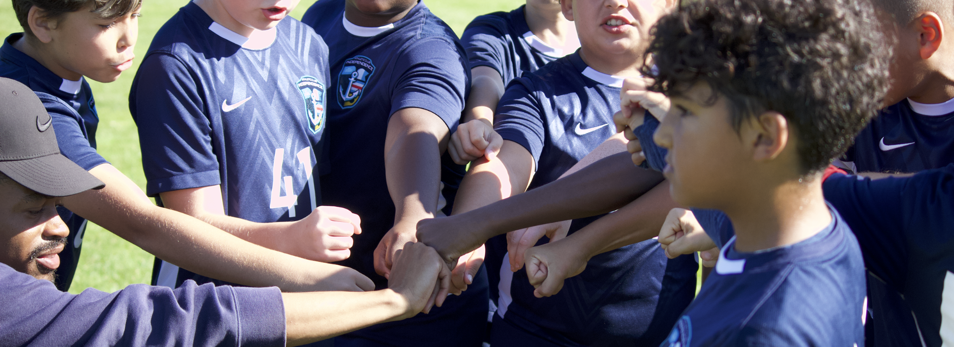 ACI Lighthouse Boys put all hands in for their pregame huddle.