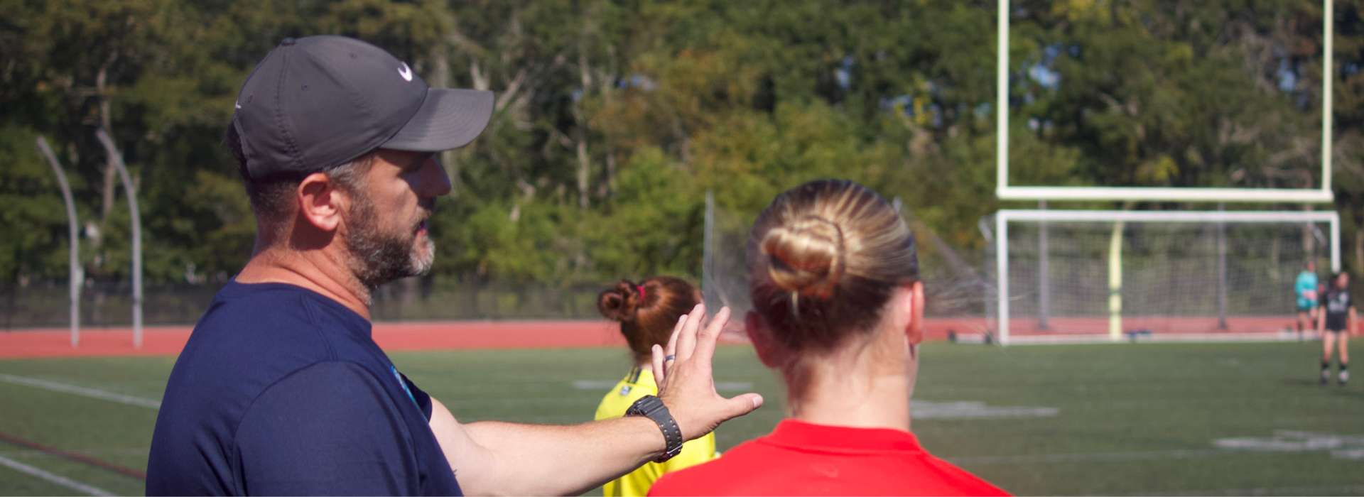 ACI Founder, Evan Botting, coaching players on the sidelines.