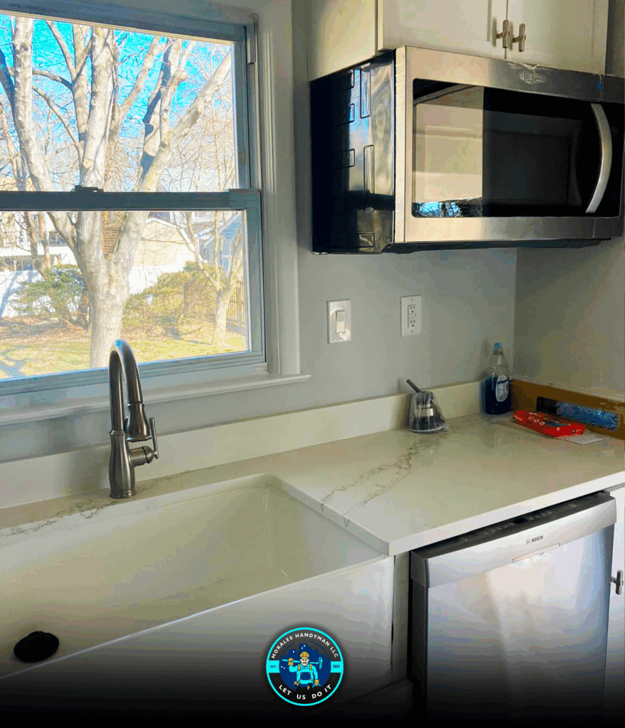 Kitchen with sink, window, microwave, and dishwasher. Bright, sunny scene.