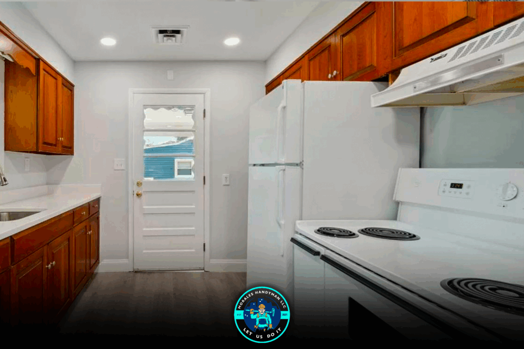 Kitchen with white appliances, wooden cabinets, and a white door leading outside.