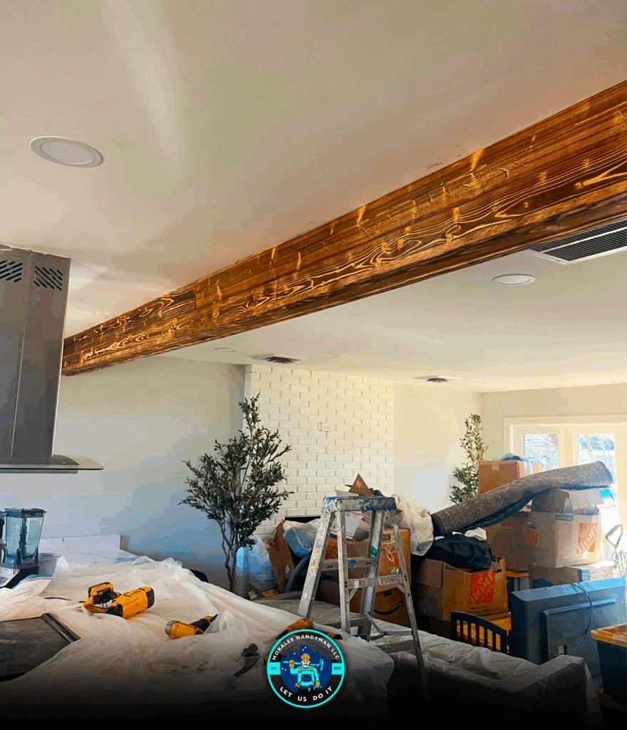 Kitchen remodel in progress with exposed beam and construction materials.