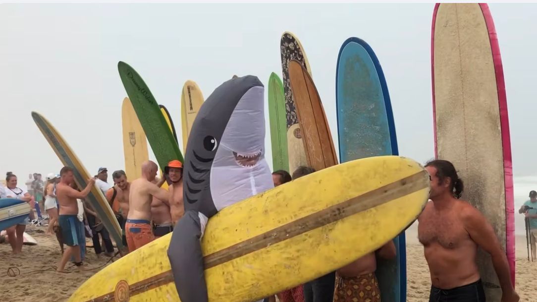 Surfers celebrate at Oldtimers Longboard competition in Wellfleet, MA on Cape Cod.