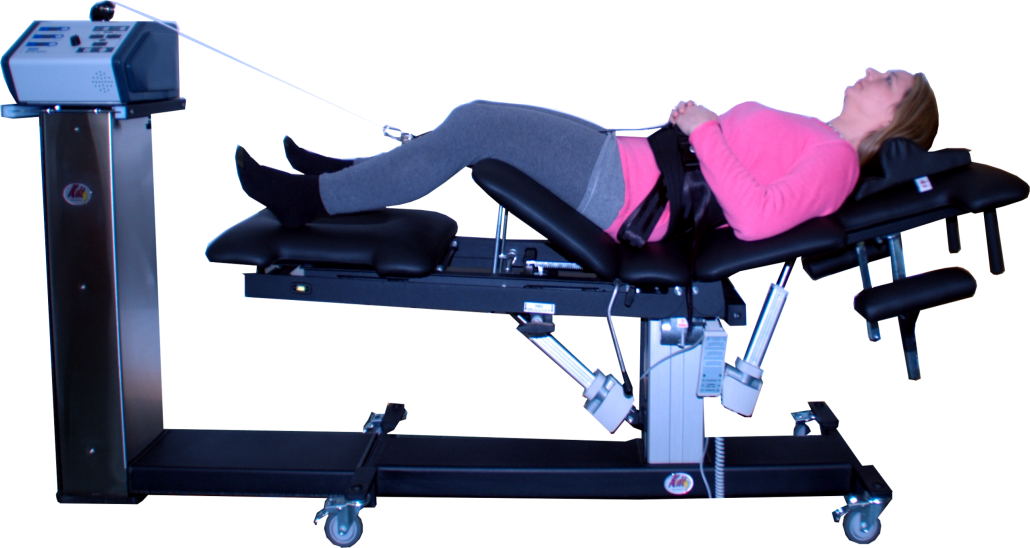 A woman is laying on a stretching machine.