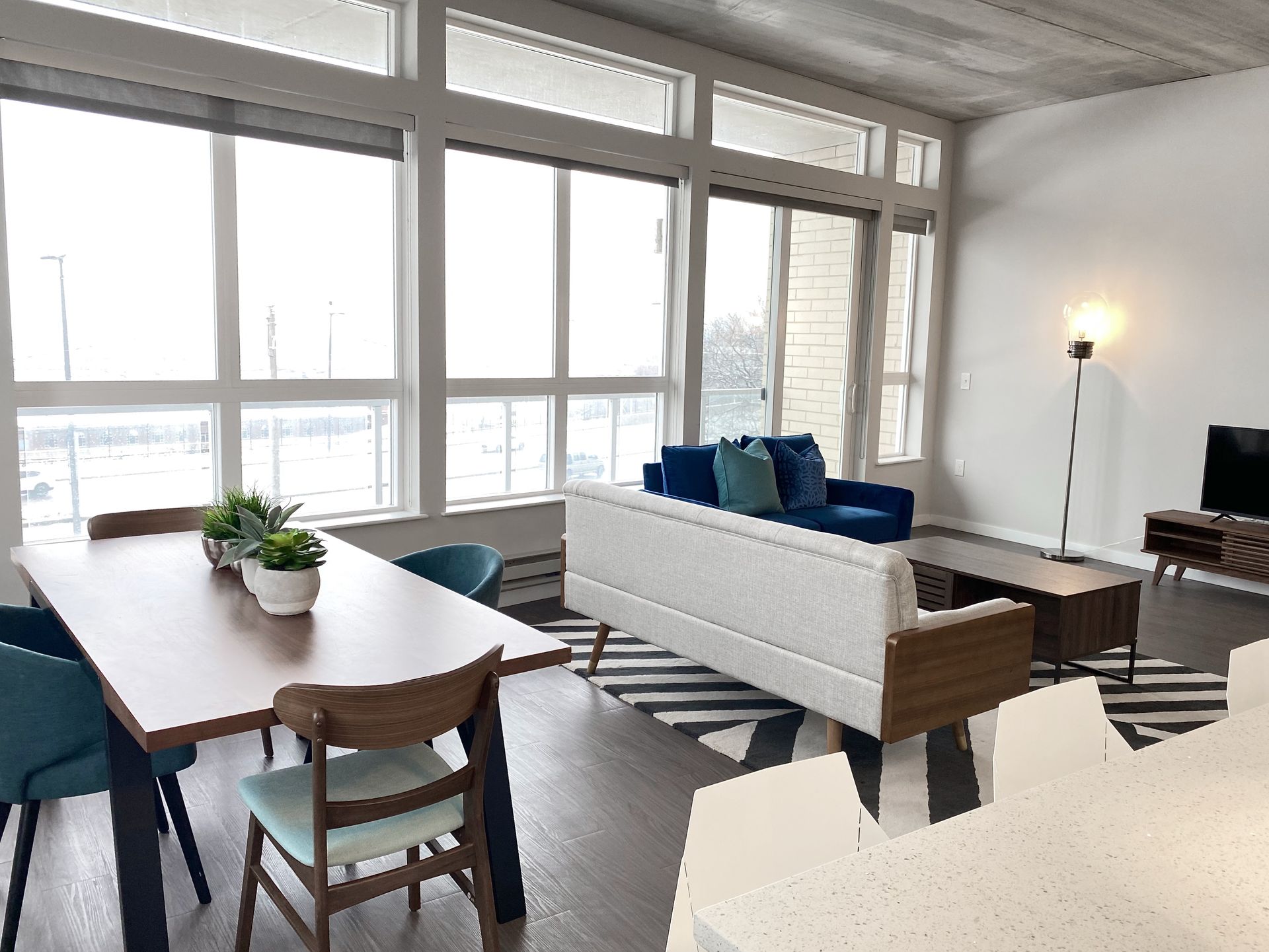 A living room with a couch , table and chairs