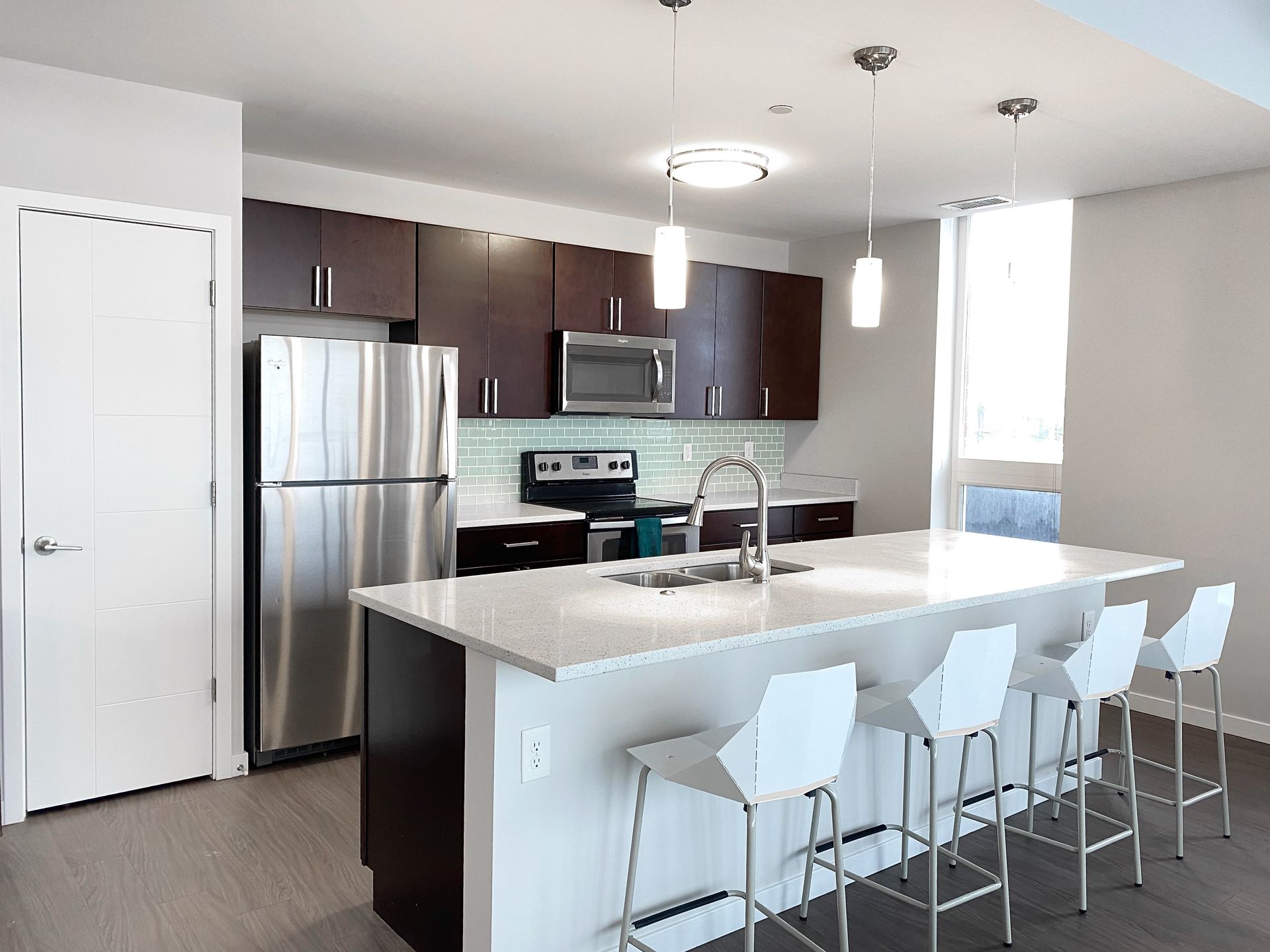 A kitchen with stainless steel appliances and a large island