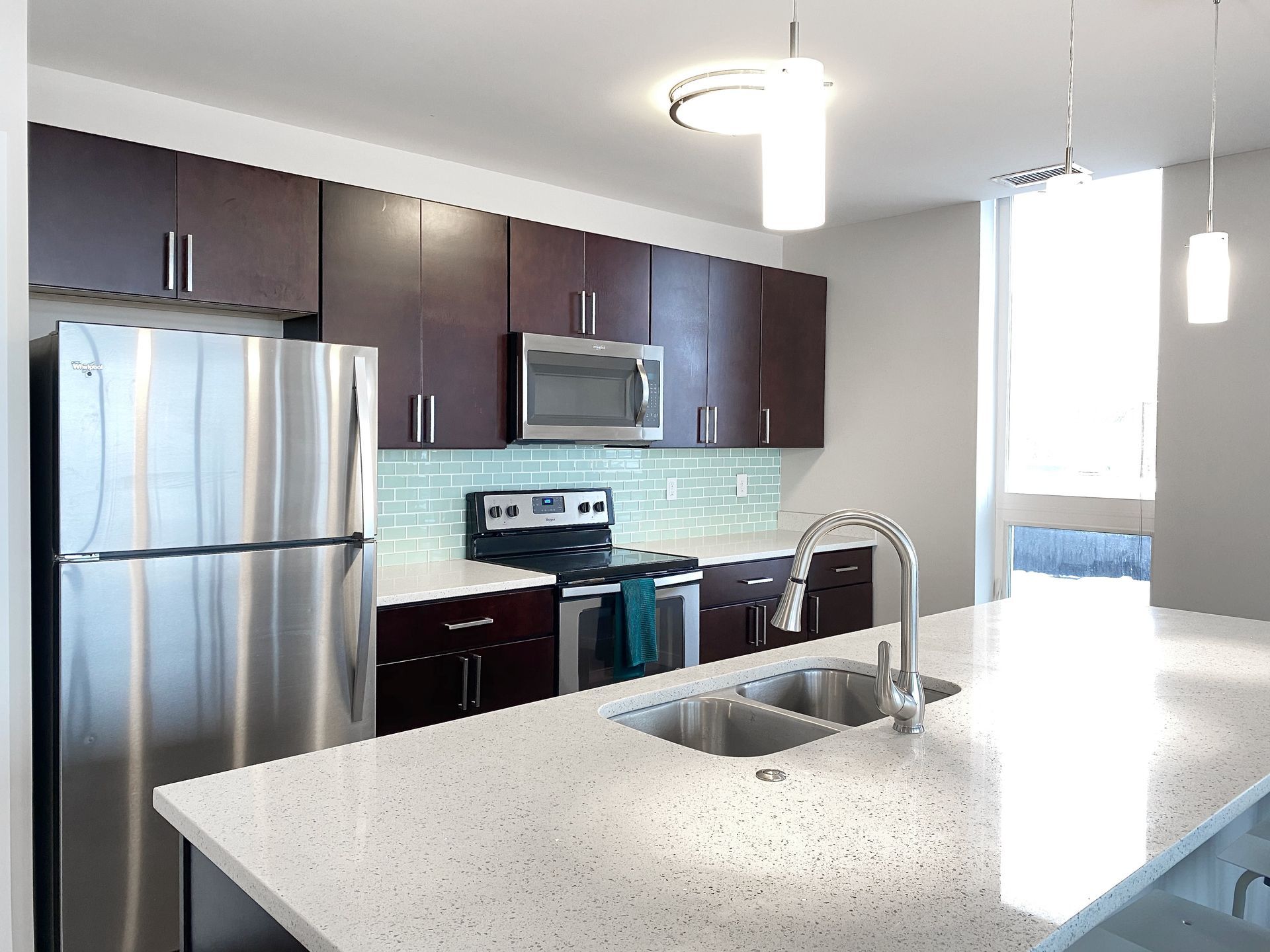 A kitchen with stainless steel appliances and granite counter tops