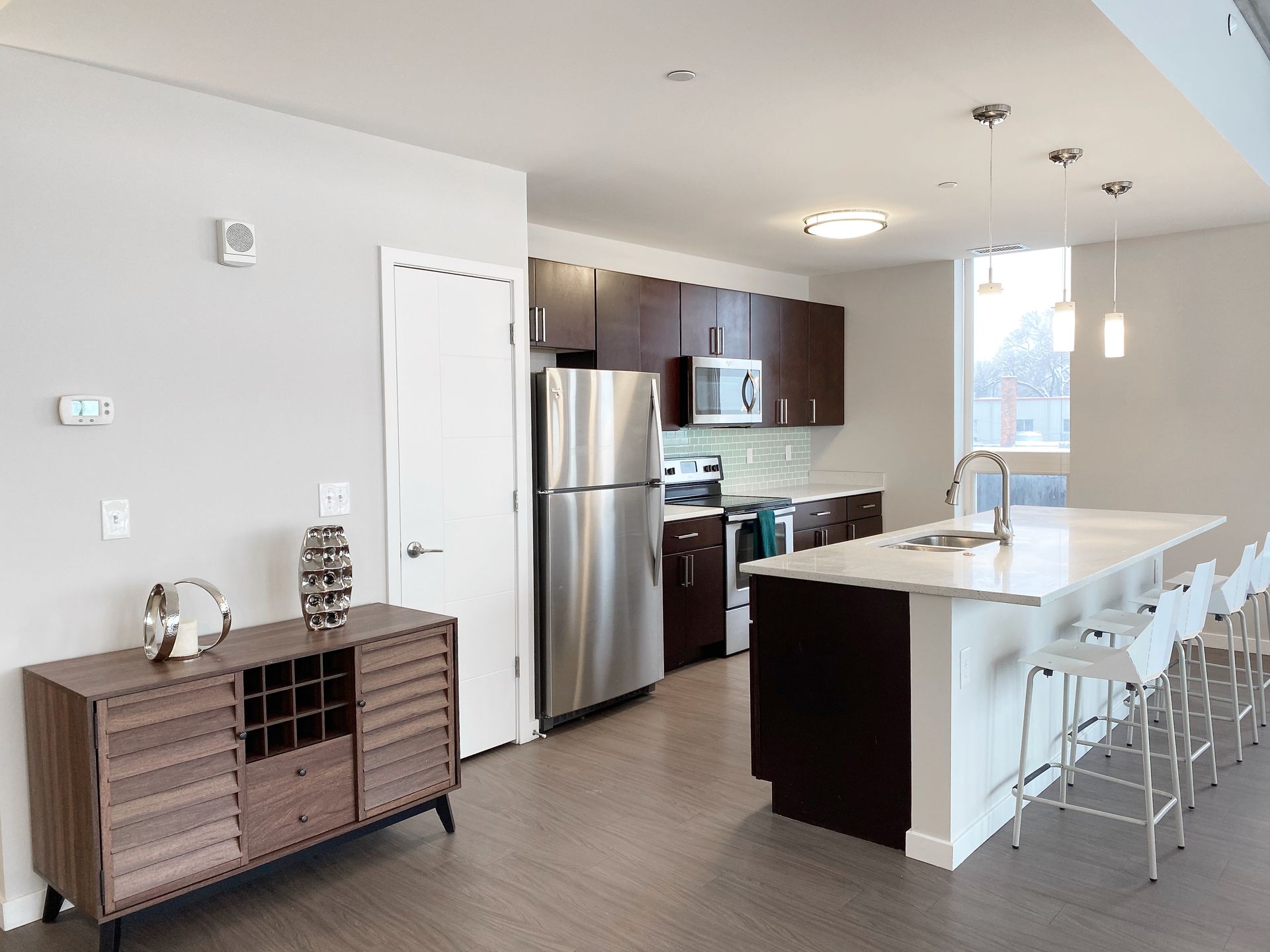 A kitchen with stainless steel appliances and a large island