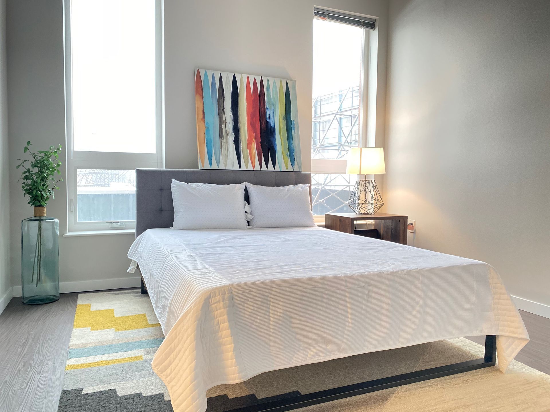 A bedroom with a bed and a painting on the wall