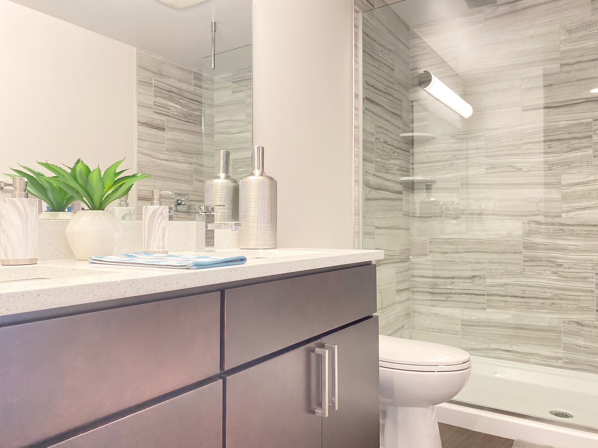 A bathroom with a toilet , sink , and shower.