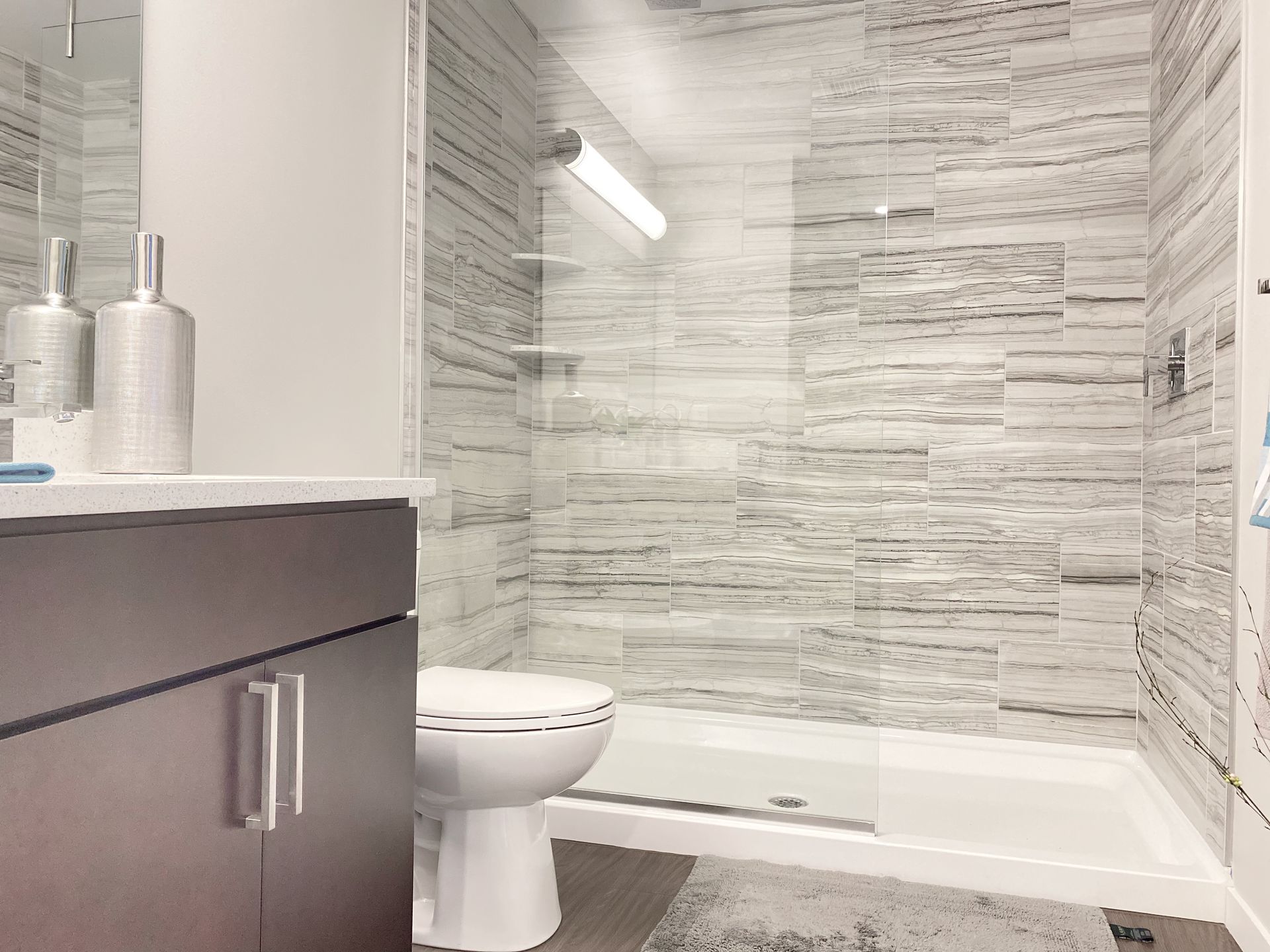 A bathroom with a toilet , sink , shower and bathtub.